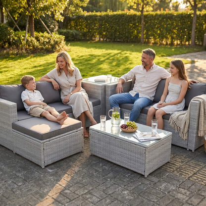 A family sitting out on a Light Grey Outdoor Rattan Garden Furniture Set