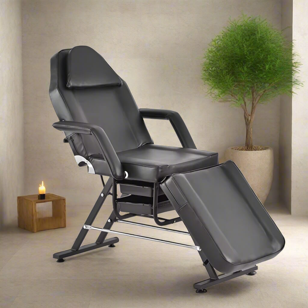A black aromatherapy massage bed and black leather stool sold by WorkZen Interiors