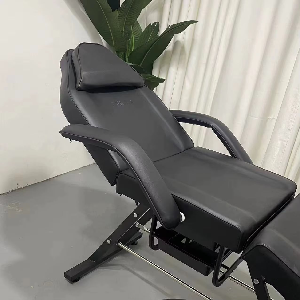 A black aromatherapy massage bed sold by WorkZen Interior
