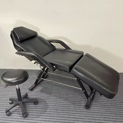 A black aromatherapy massage bed and a black stool sold by WorkZen Interior