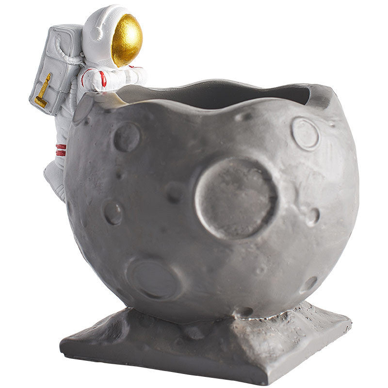 A Astronaut Desk Pen Holder sold by WorkZen Interiors