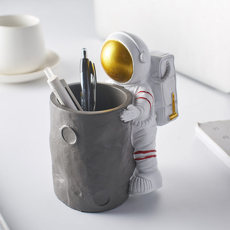 A Astronaut Desk Pen Holder sold by WorkZen Interiors