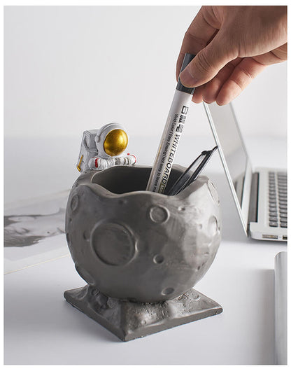 A Astronaut Desk Pen Holder sold by WorkZen Interiors