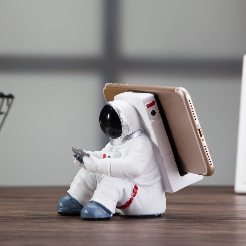 A white astronaut desk phone holder sold by WorkZen Interiors