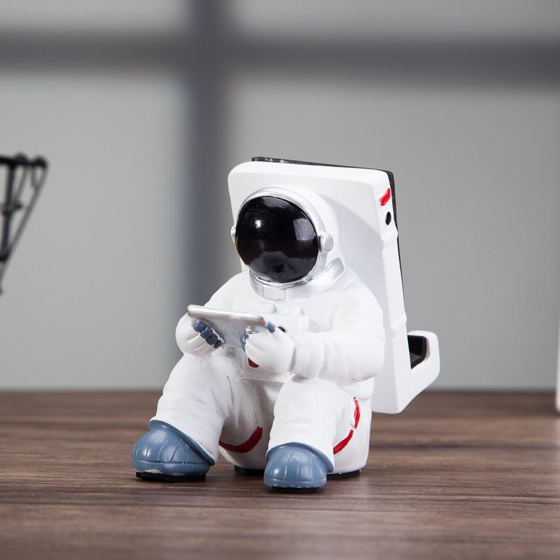 A white astronaut desk phone holder sold by WorkZen Interiors