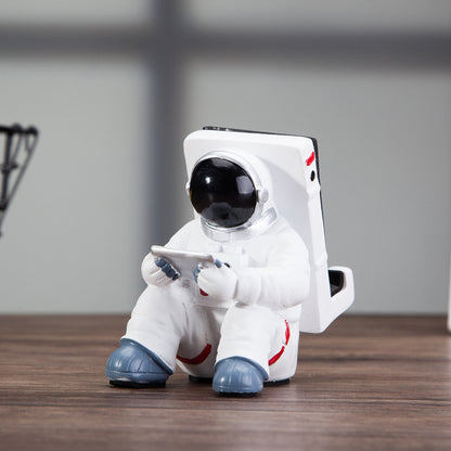 A white astronaut desk phone holder sold by WorkZen Interiors