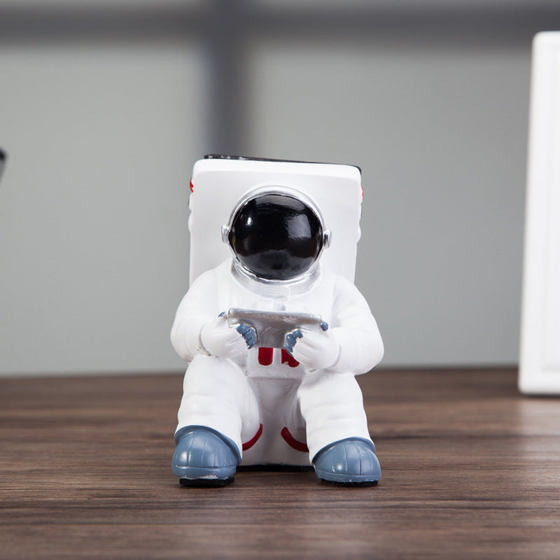 A white astronaut desk phone holder sold by WorkZen Interiors