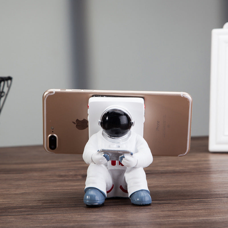 A white astronaut desk phone holder sold by WorkZen Interiors