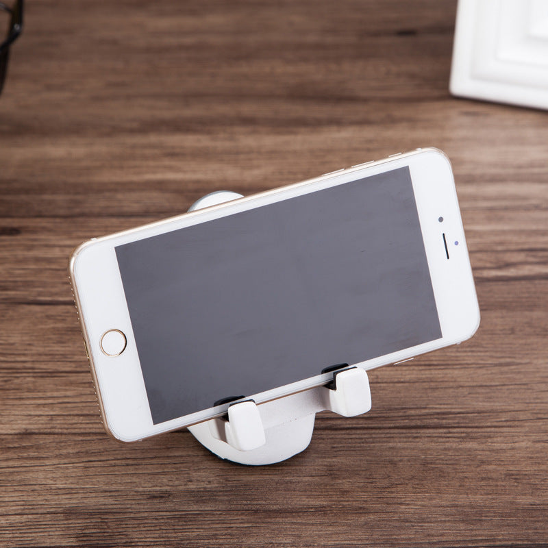A white astronaut desk phone holder sold by WorkZen Interiors