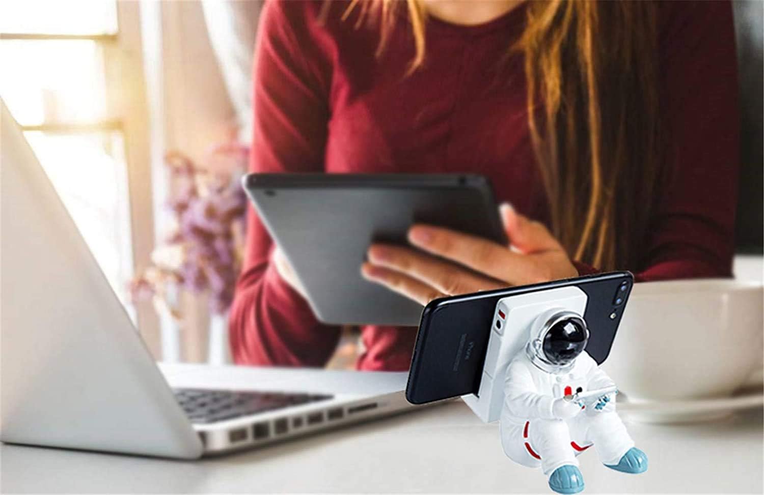 A white astronaut desk phone holder sold by WorkZen Interiors