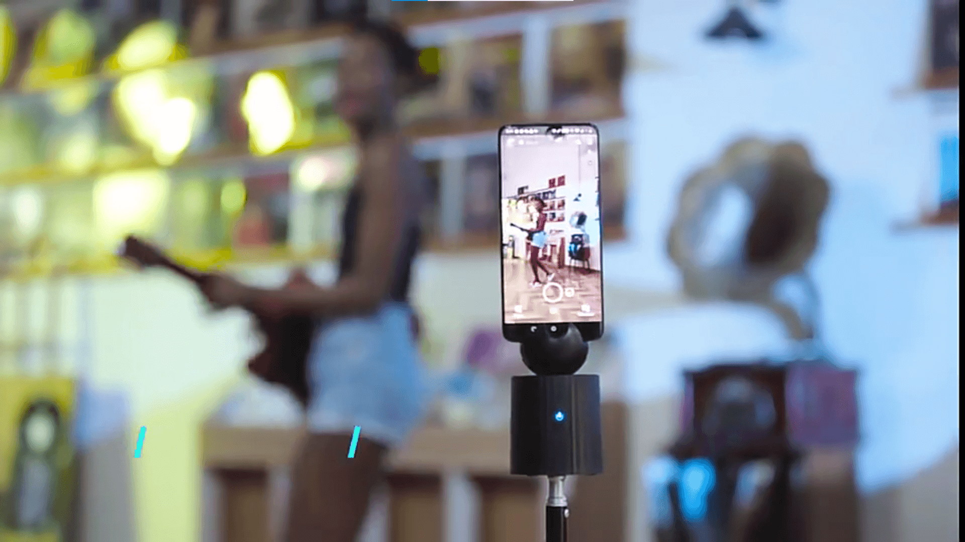 A black auto object tracking phone holder sold by WorkZen Interiors