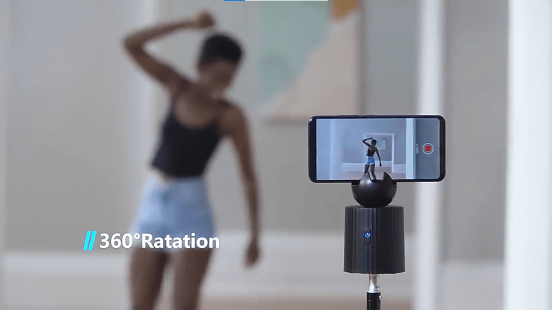 A black auto object tracking phone holder sold by WorkZen Interiors