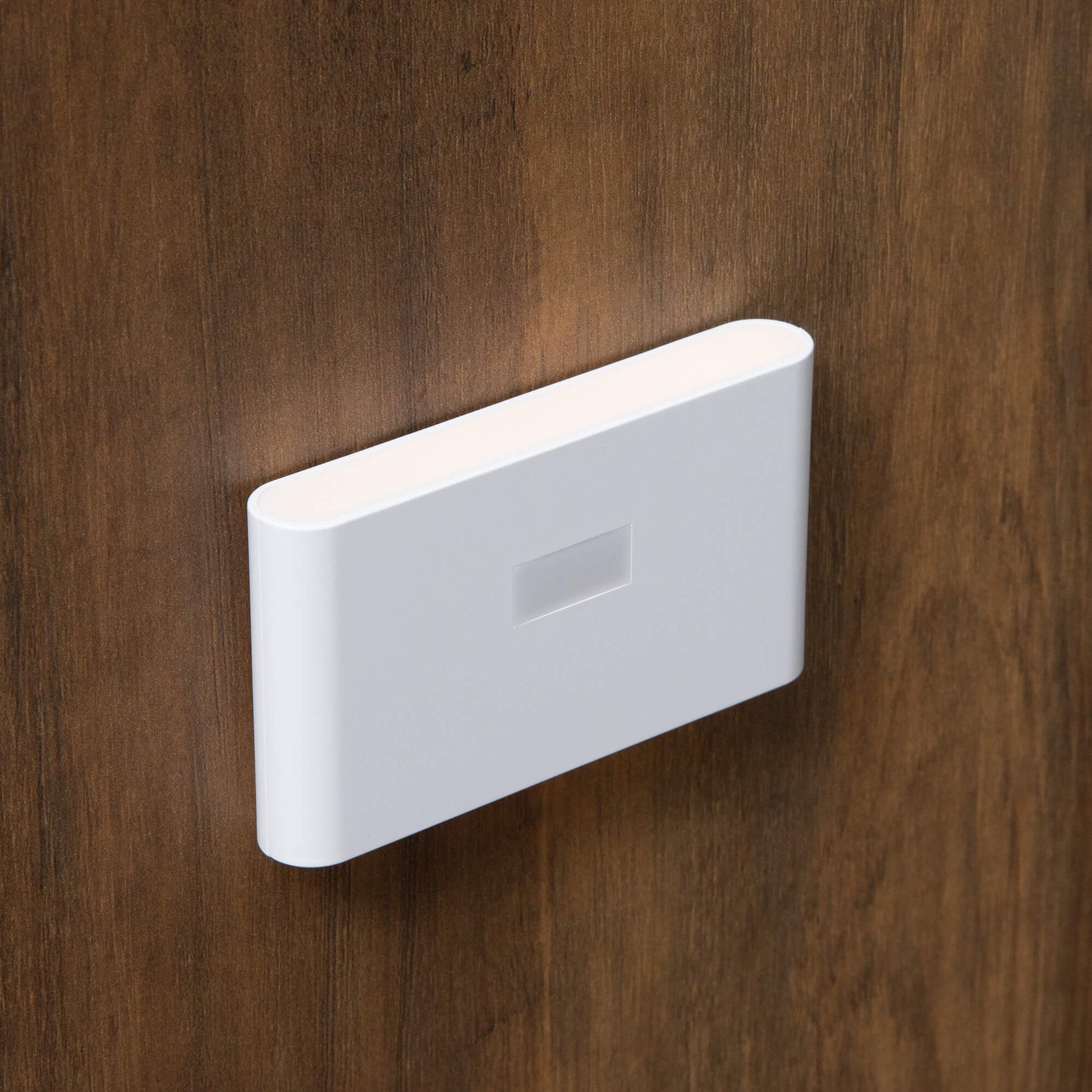 A motion detection device for a brown coat rack with shoe storage sold by WorkZen Interiors