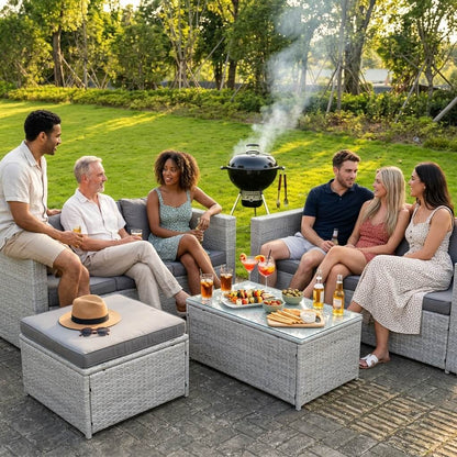 Some group of friends sitting on Light Grey Outdoor Rattan Garden Furniture Set in a back garden