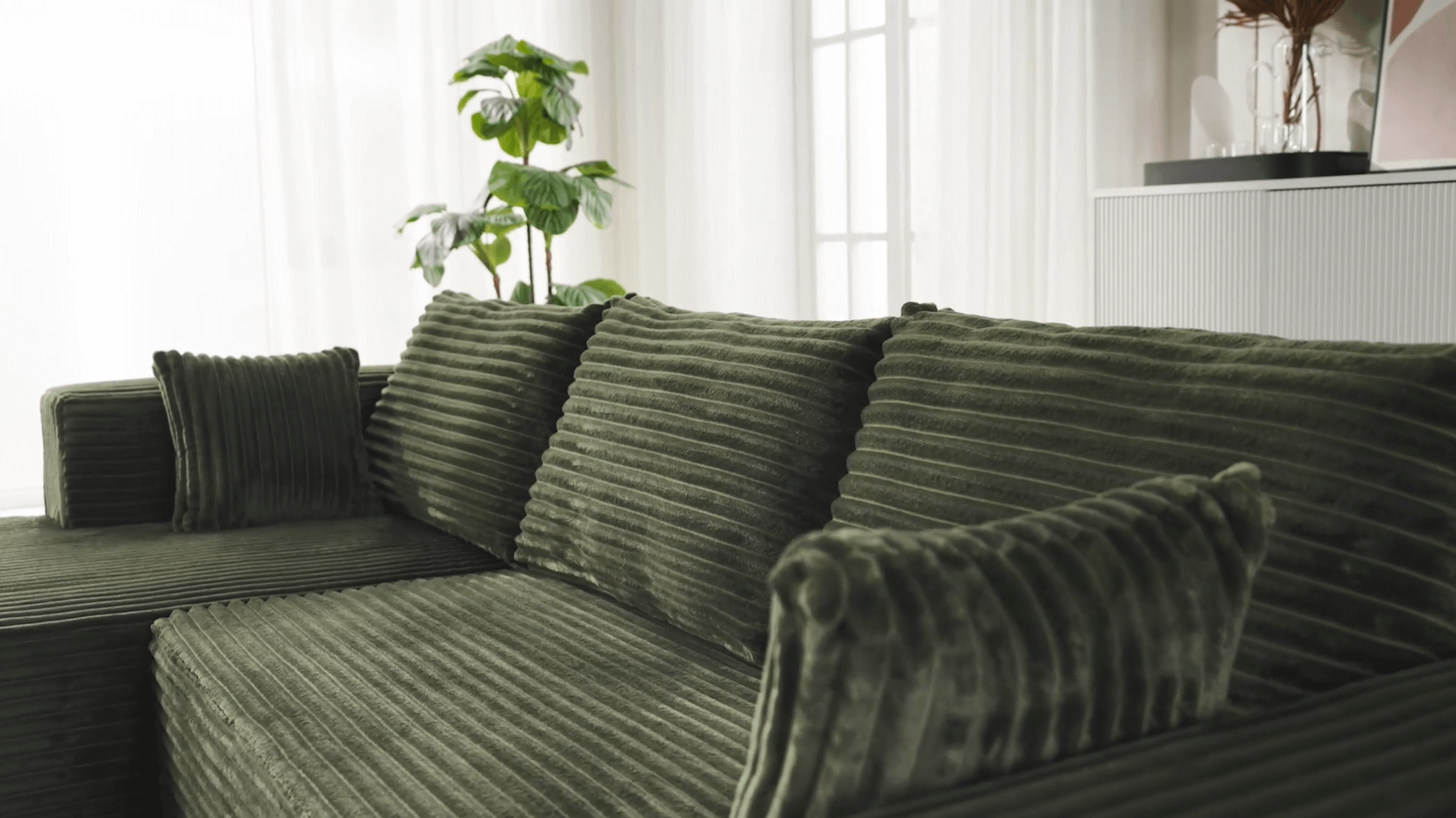 A green sectional sofa sold by WorkZen Interiors