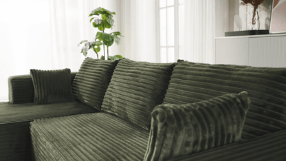A green sectional sofa sold by WorkZen Interiors