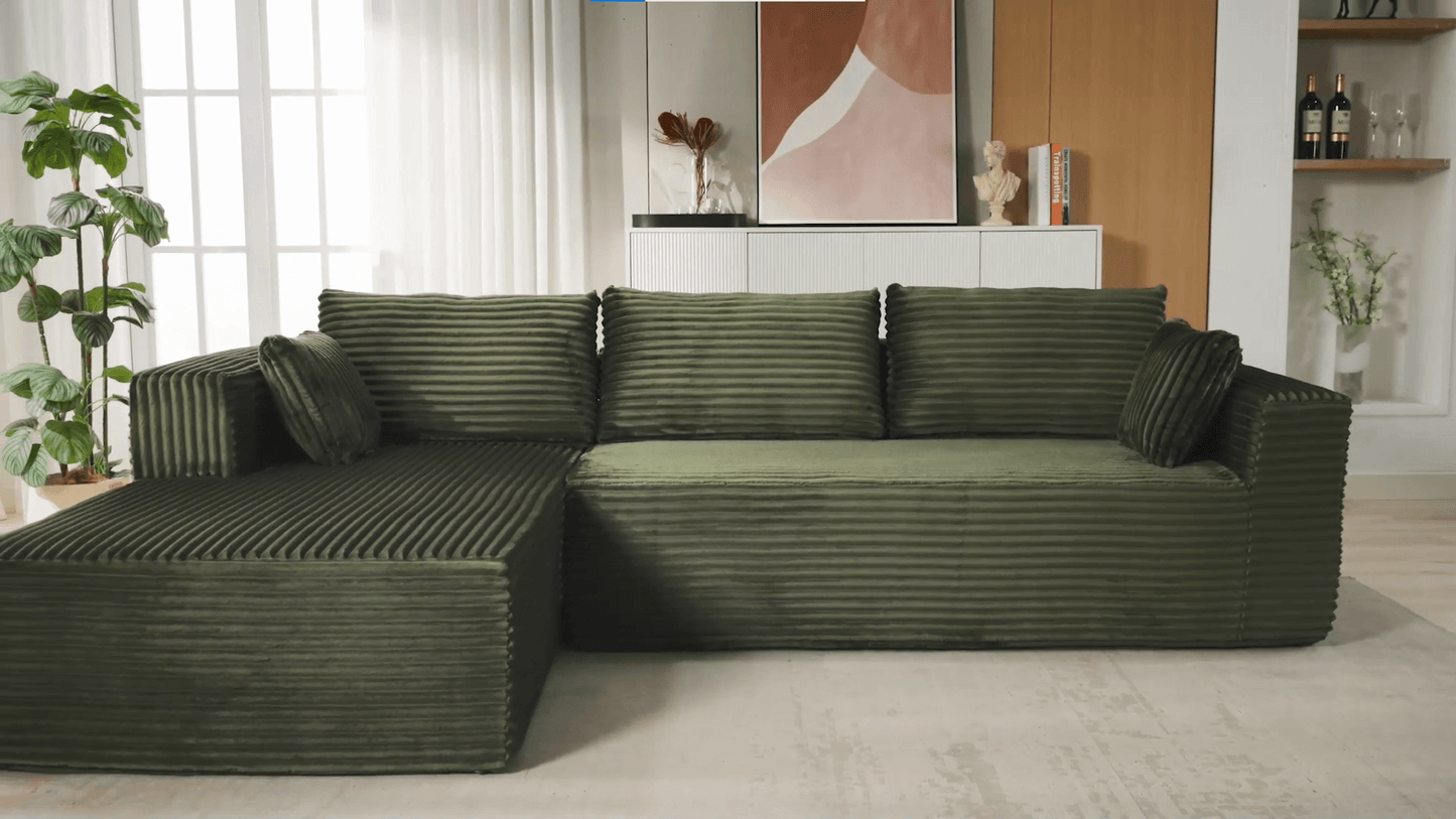 A green sectional sofa sold by WorkZen Interiors