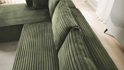A green sectional sofa sold by WorkZen Interiors