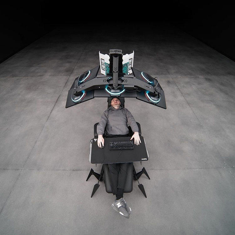 Person sitting in a scorpion gaming chair on a dark floor.