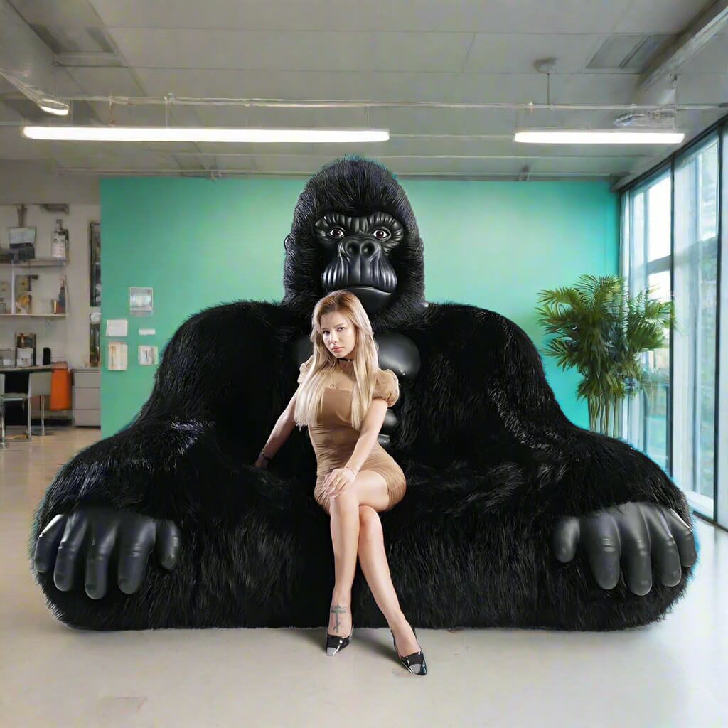 A black inflatable gorilla sofa sold by WorkZen Interiors with a beautiful woman sitting on it.