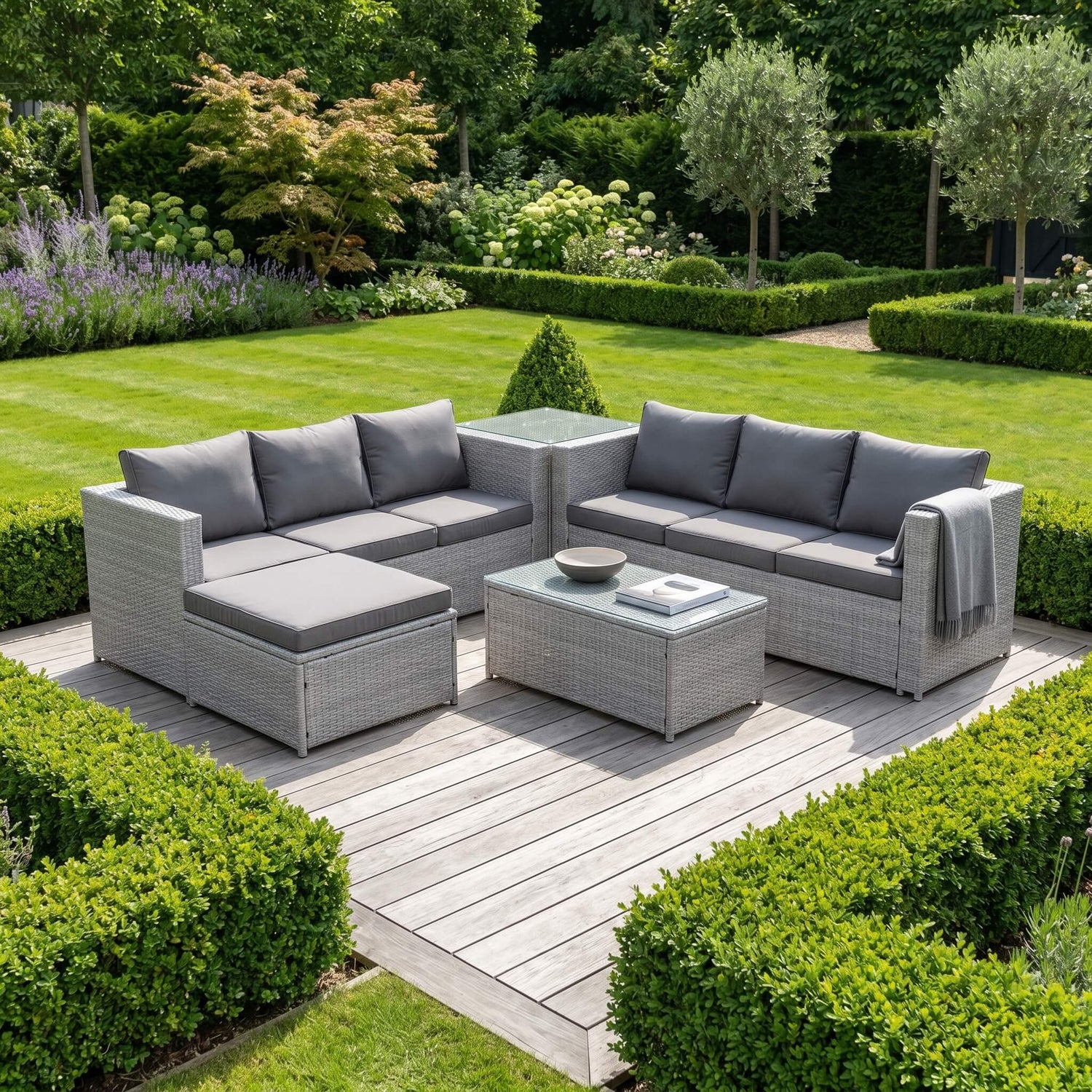 A Light Grey Outdoor Rattan Garden Furniture Set in an out garden