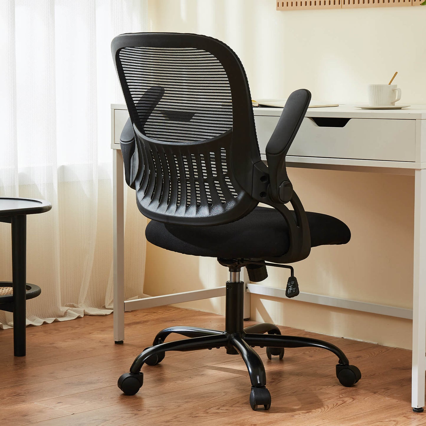 An adjustable armrest black mesh back office desk chair sold by WorkZen Interiors