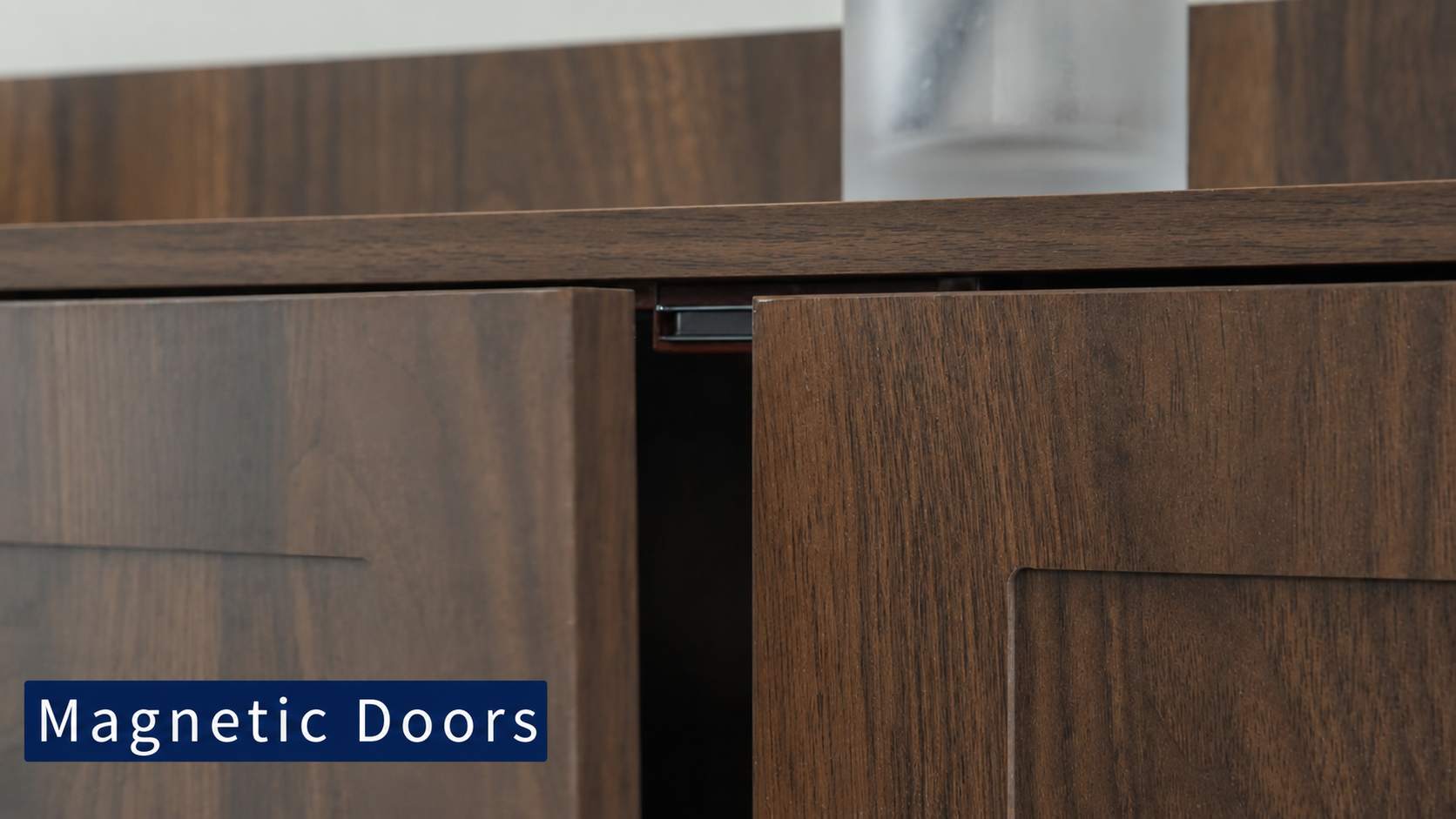 Close-up of dark wood toilet paper storage cabinet​ doors with one door slightly open, showing a magnetic door hardware detail and a text overlay that reads 'Magnetic Doors'.