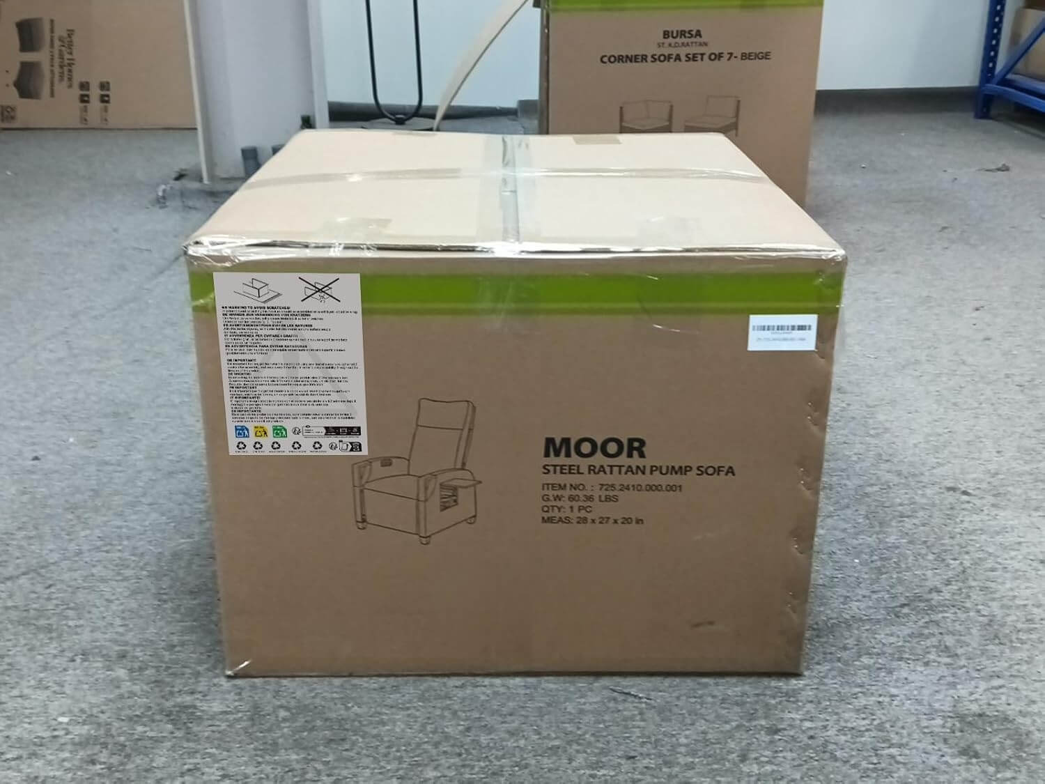 Cardboard box with 'MOOR' branding on a gray floor