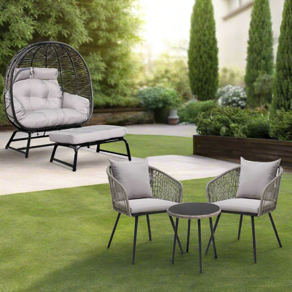 Outdoor patio set with chairs, table, and egg-shaped chair in a garden setting.