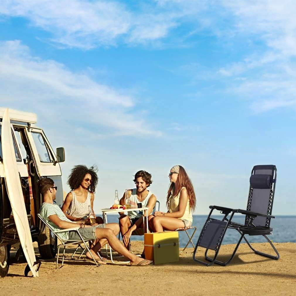 Group of people sitting around a table outdoors with a scenic background
