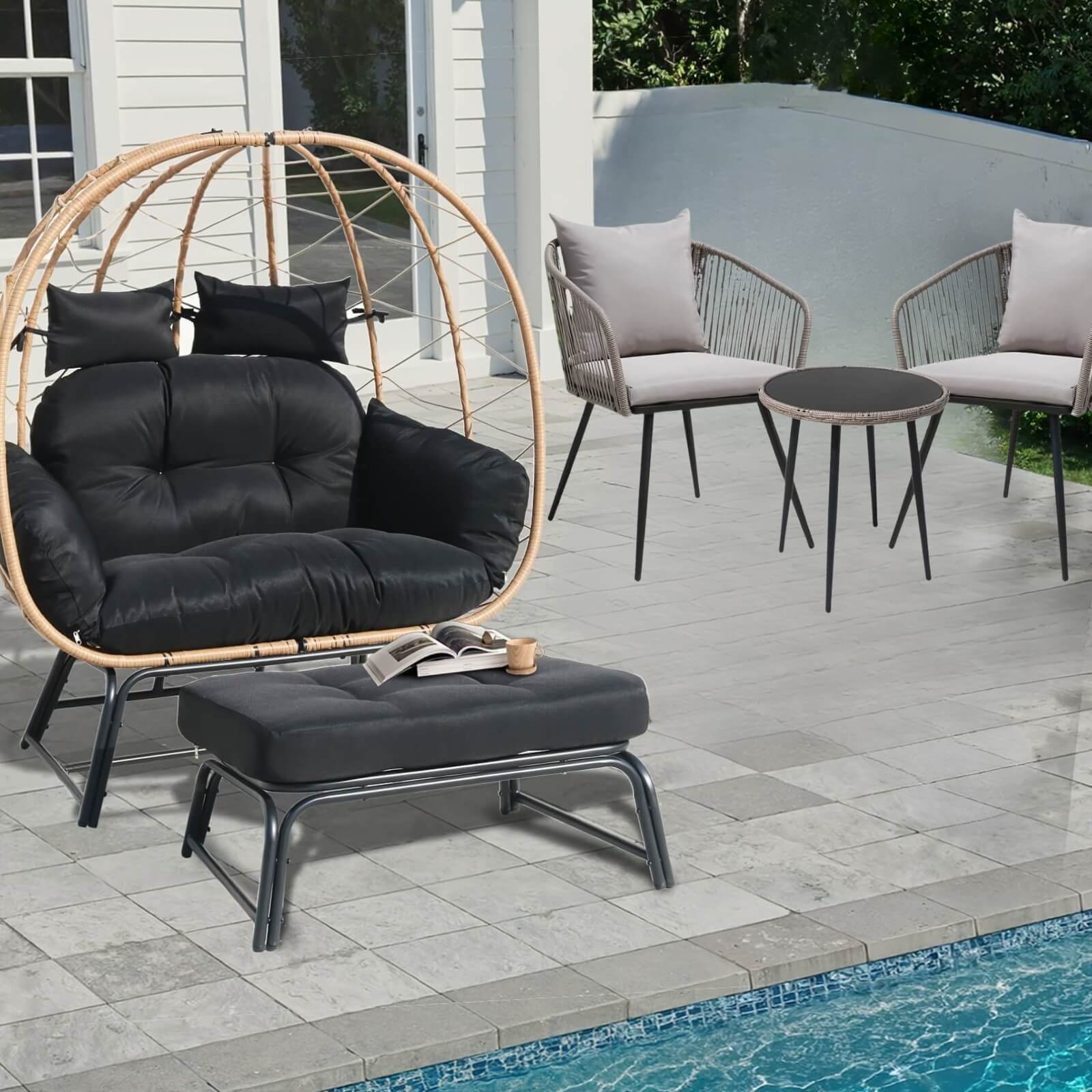Outdoor patio furniture set with a black cushioned chair, ottoman, and small table by a pool.
