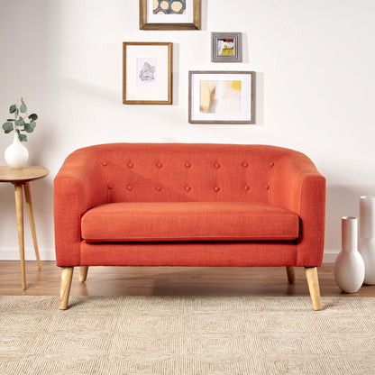 The front of an orange lounger sofa sold by WorkZen Interiors