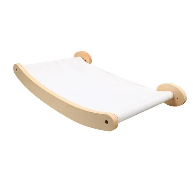 A minimalist wooden wall-mounted cat hammock with a curved natural wood frame and a white fabric sling, shown against a plain white background.