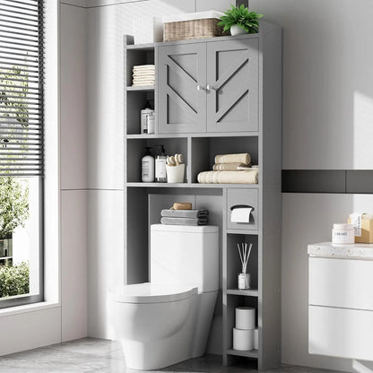 A tall gray above the toilet storage cabinets​ with a toilet cover insert, shown in a modern bathroom setting next to a window and vanity.
