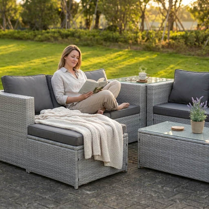 A woman reading on a Light Grey Outdoor Rattan Garden Furniture Set