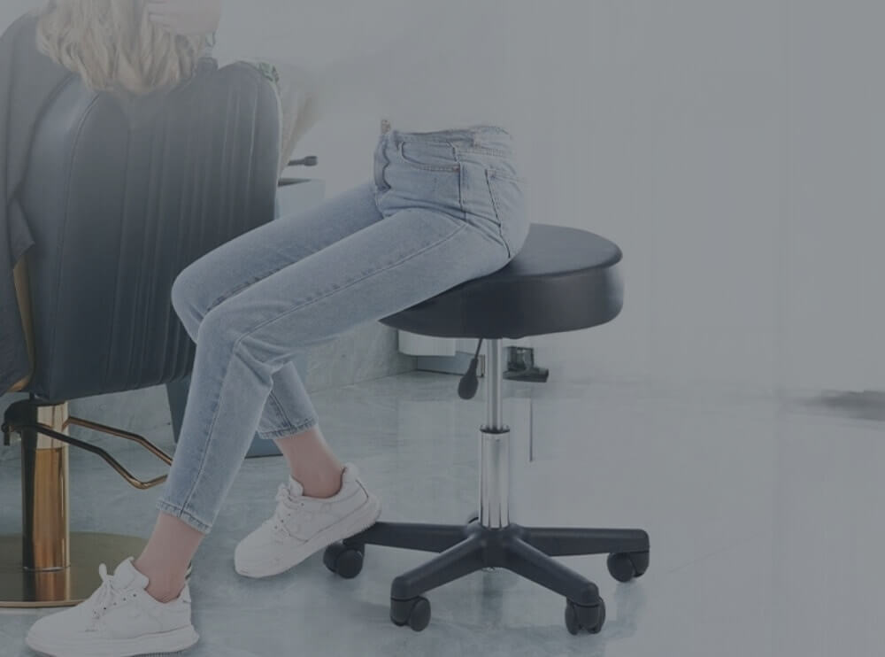 A leather stool with a woman sitting on it.