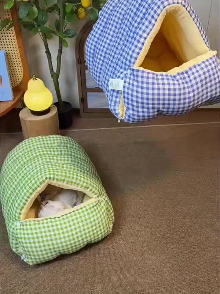Two checkered wool cat cave, one green and one blue and white, on a carpeted floor.
