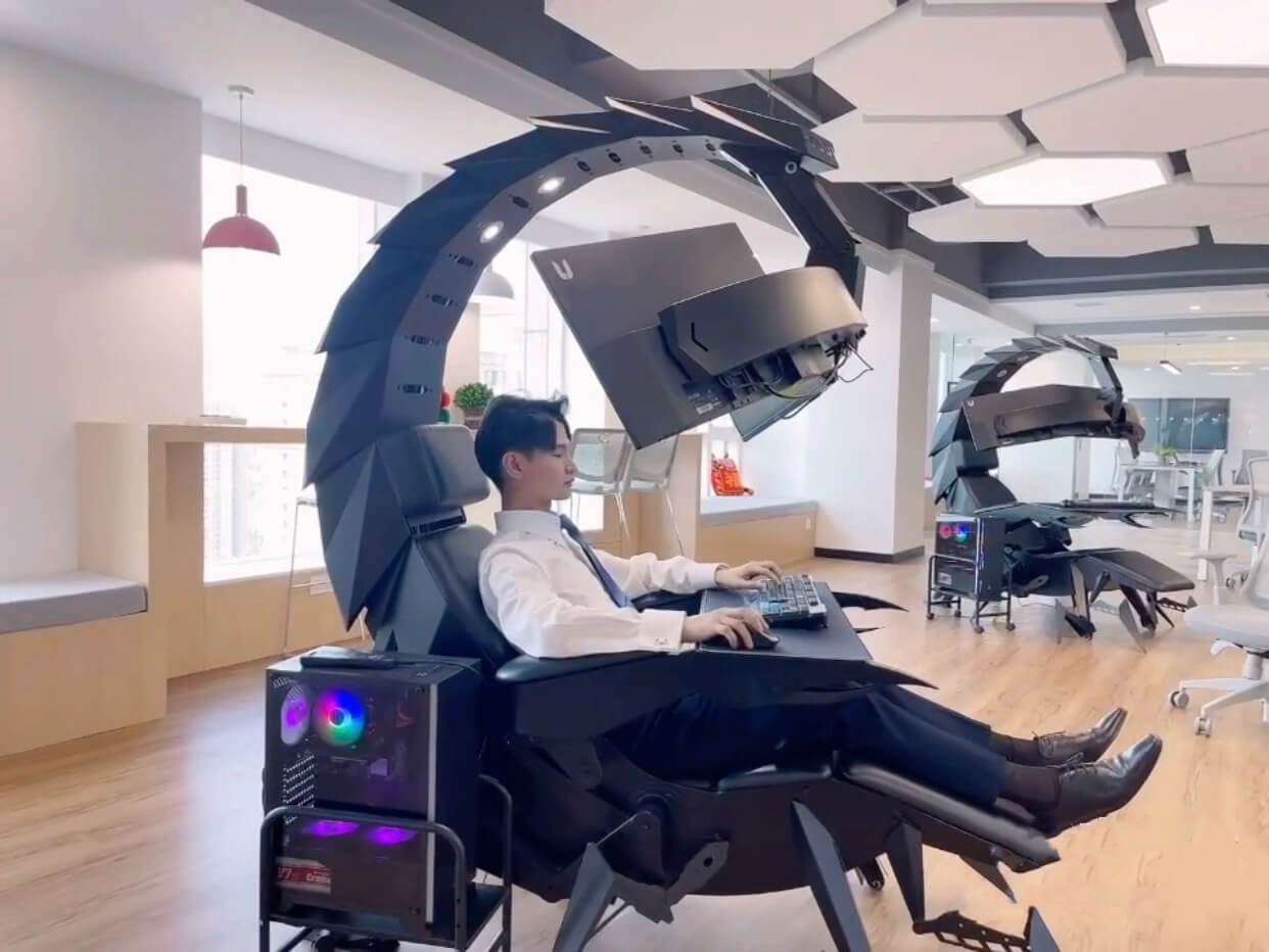 Person using a scorpion gaming chair with high-tech equipment in an office setting