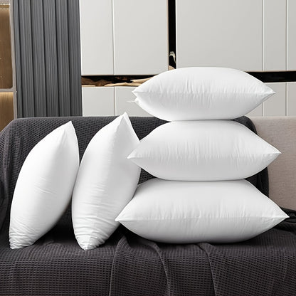 White pillows on a gray sofa in a modern room setting