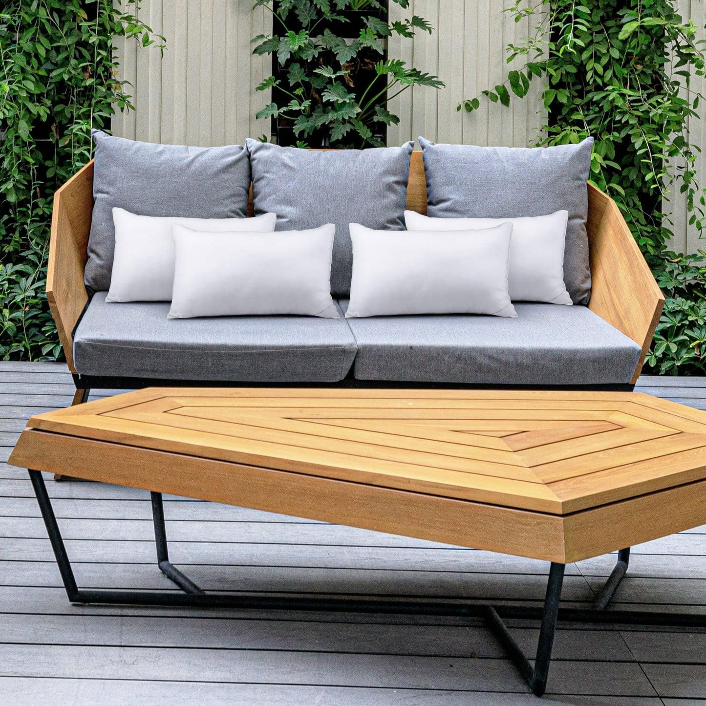 Outdoor furniture set with a wooden sofa and hexagonal coffee table on a patio.