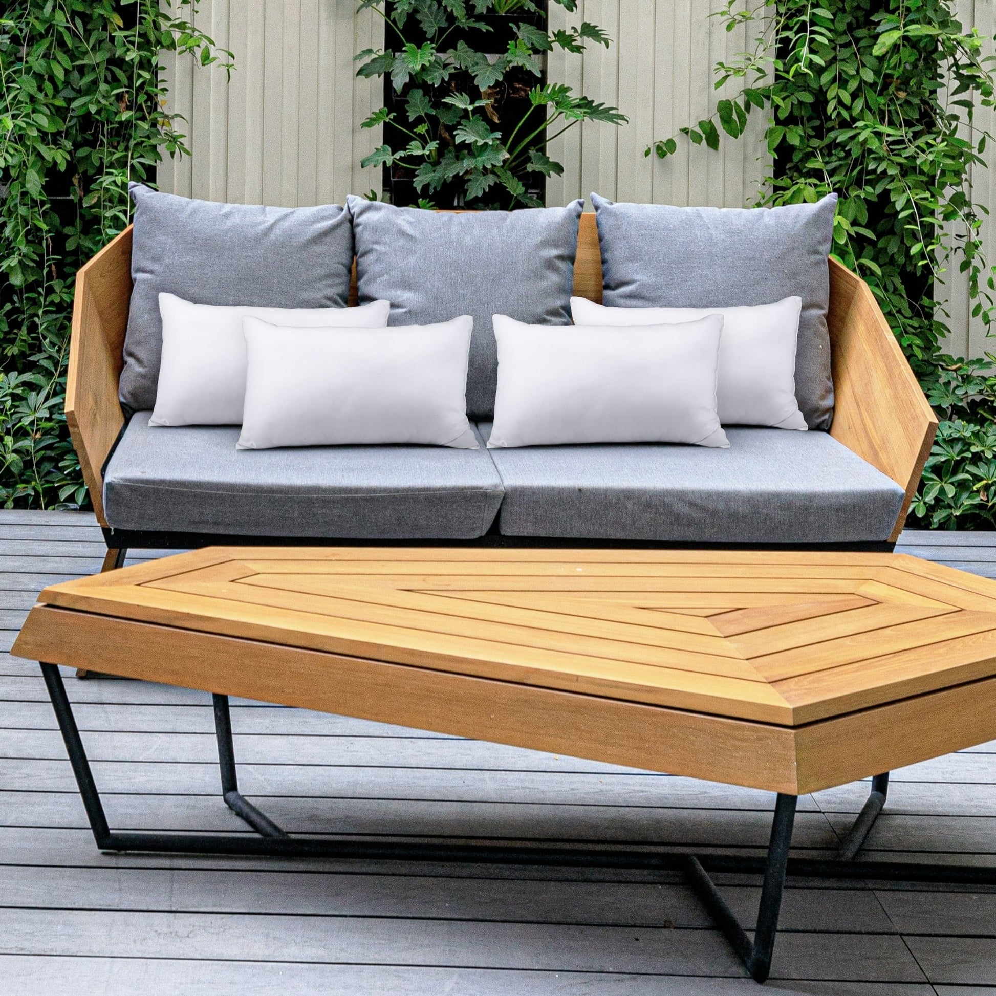 Outdoor furniture set with a wooden sofa and hexagonal coffee table on a patio.