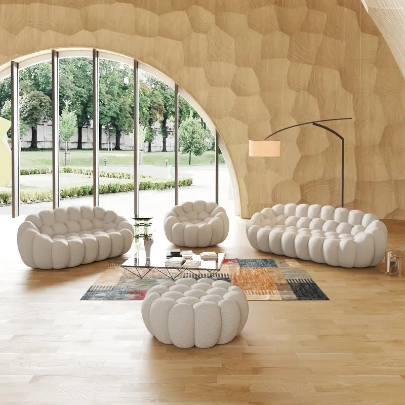 Modern living room with white bubble sofas and large windows.
