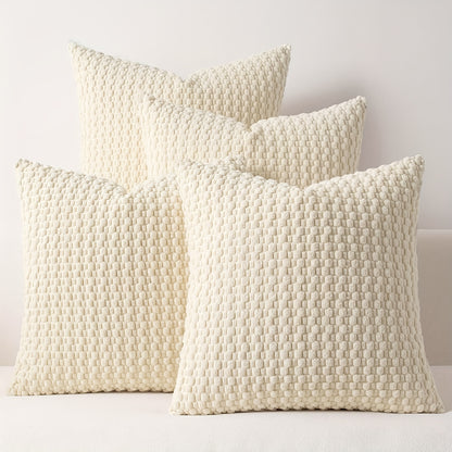 Three textured cream pillows on a light background
