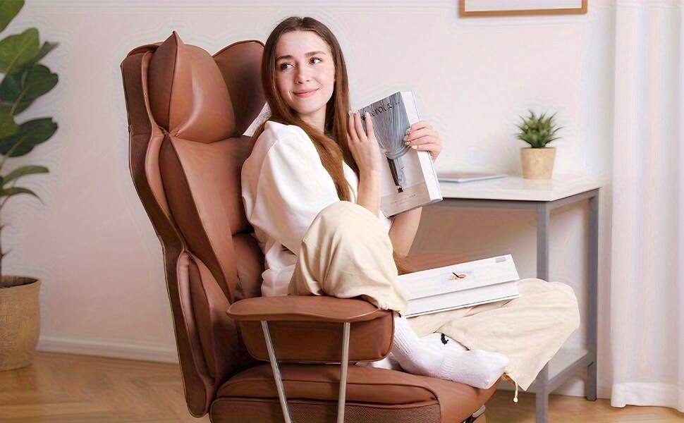 Woman sitting in a brown executive leather chair holding a magazine in a home setting.