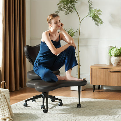 Woman sitting on a black office chair in a home setting with plants and furniture.