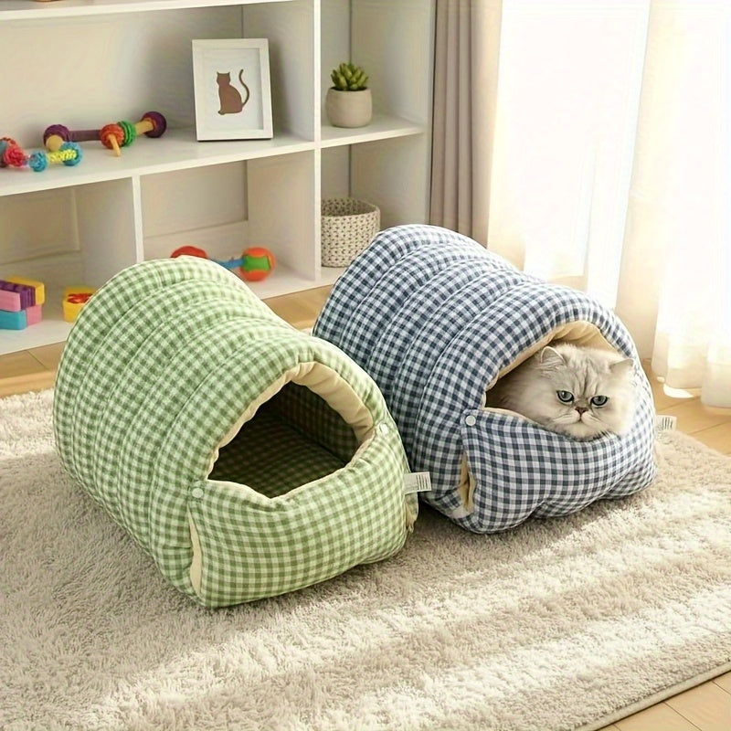 Two checkered wool cat cave, one green and one blue, with a cat peeking out on a carpeted floor.