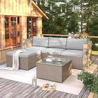 Outdoor patio set with sectional sofa and coffee table on a wooden deck.