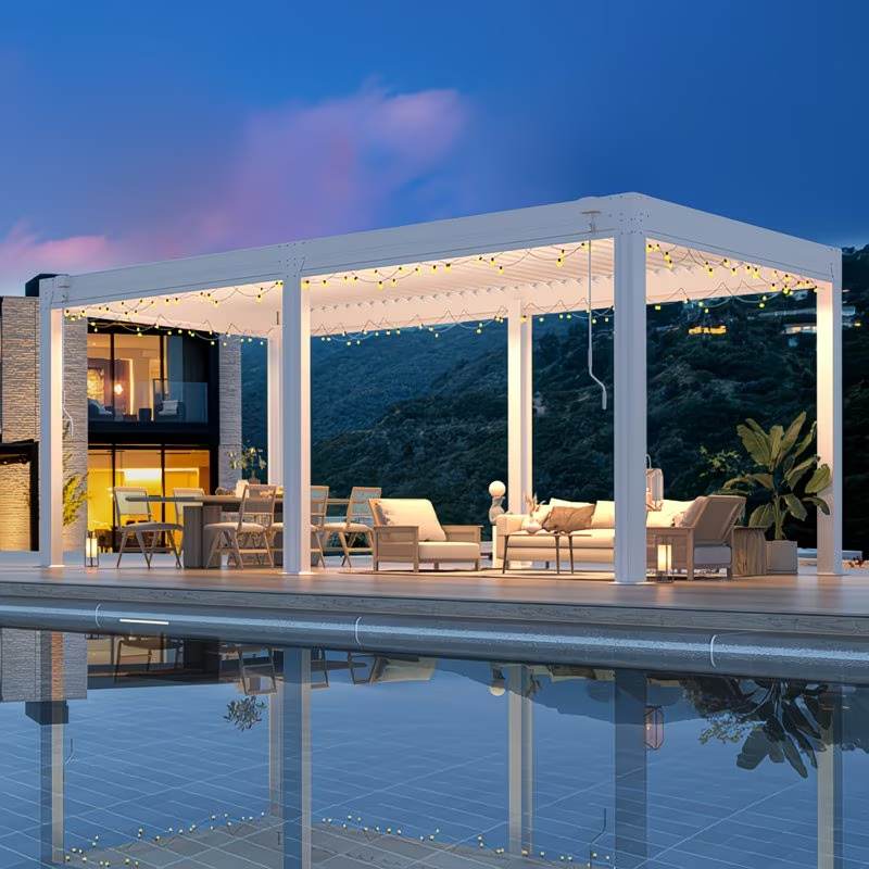 Modern outdoor patio with pergola, furniture, and pool at night.