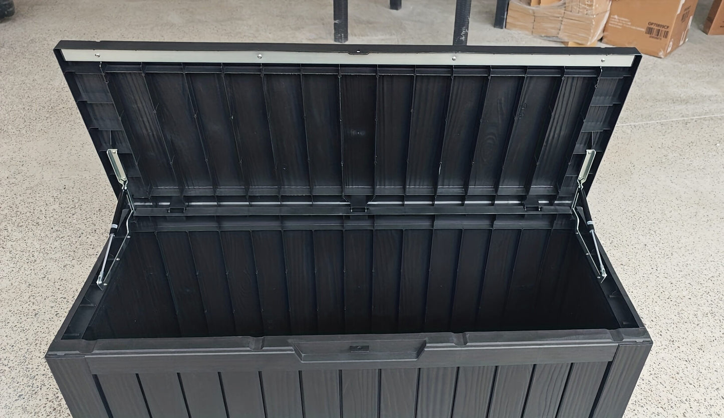 Black storage box with a lid on a concrete floor