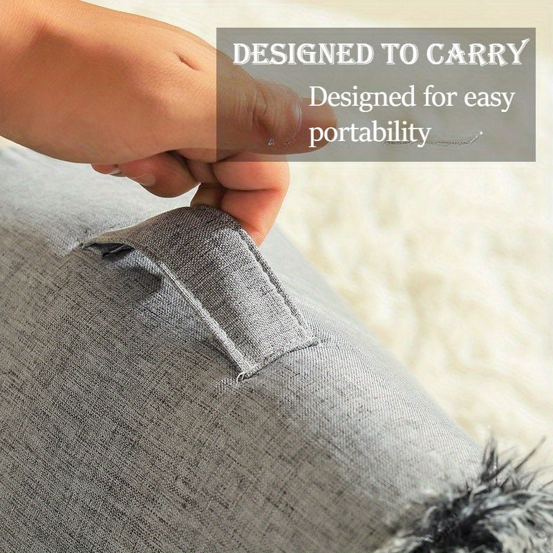 Gray cat cave bed with a hand holding it.